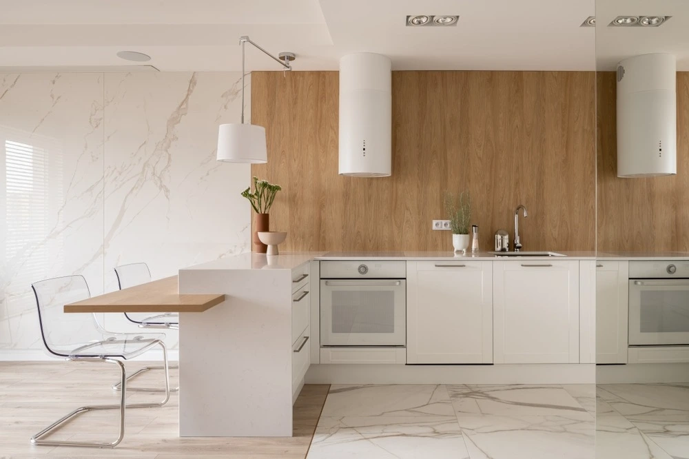 Modern and minimal kitchen with sleek, simple white cabinets.