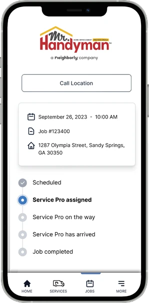 Neighborly App job progress marked 'Service Pro assigned' displayed on smartphone screen.