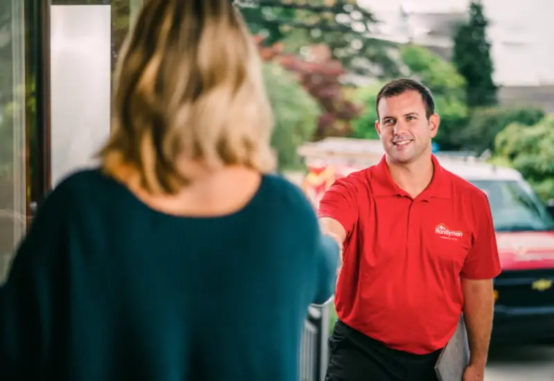 A handyman technician greeting a client.